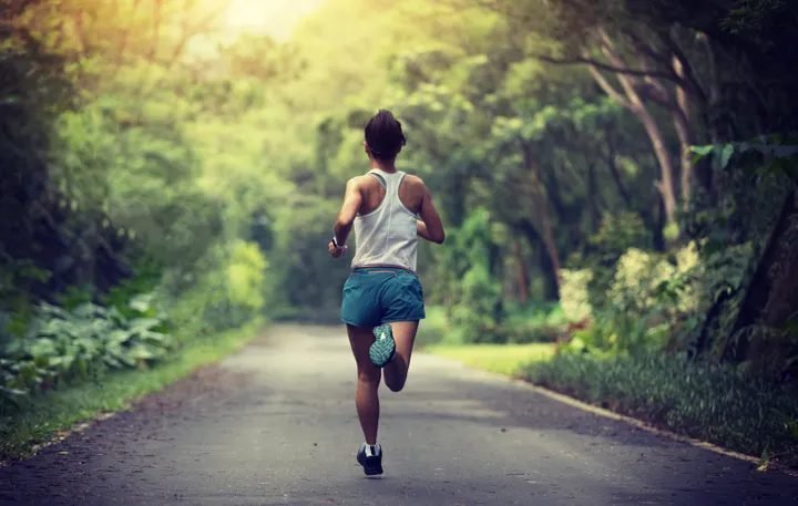 A runner on a road, photographed from the knees down